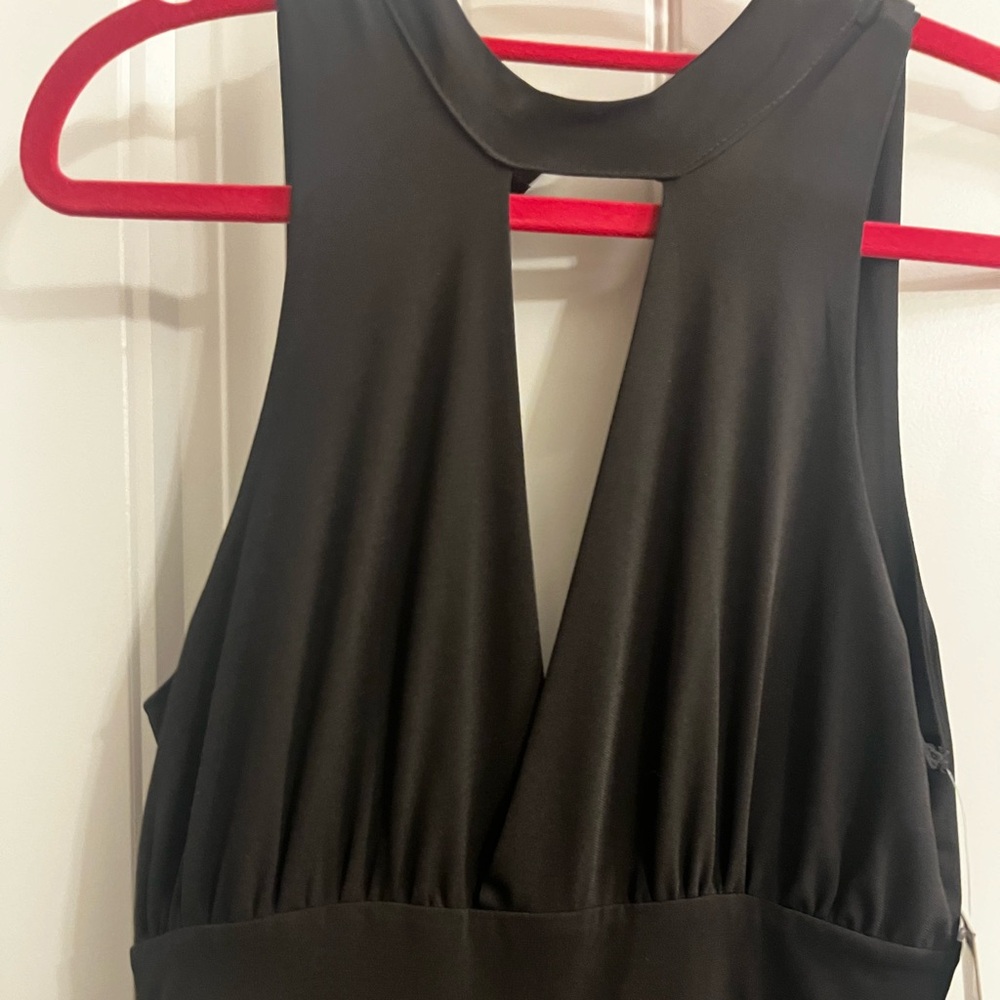 Black wide leg romper with deep V neckline. Size M